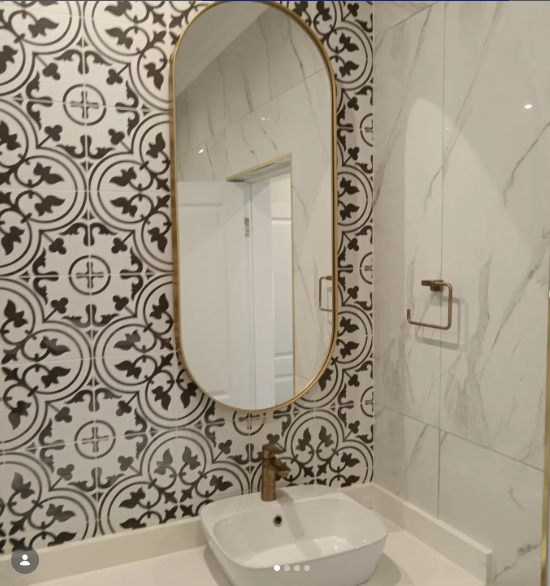 Full bathroom renovation with patterned feature wall and marble finishes — Durban South